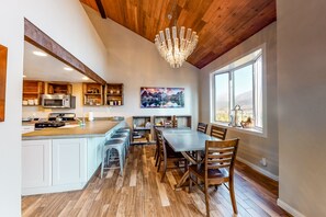 Enjoy meals in the kitchen with a large island and dining area featuring a table and chairs.