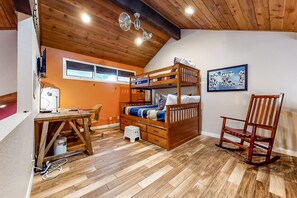 Enjoy a cozy stay in this room featuring a bunk bed, desk, and comfortable seating area.