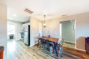 Enjoy meals in the kitchen with a central island and dining area featuring a table and chairs.