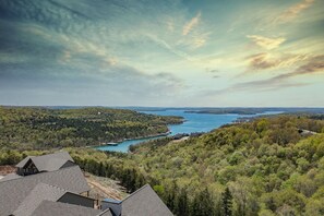 A residential area with houses overlooking a lake, surrounded by dense forest. - Crown Jewel | Table Rock Lake Views | Sleeps 24 | Near Silver Dollar City (Indian Point)