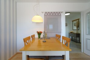 Dining - The cozy living room, with balcony, real wood flooring, solid wood furniture, large 43" Smart TV, Grundig compact system with radio, W'Lan, CD player and Bluetooth, dining table with chairs for 4 people and a high-quality sofa bed (with... (Westerland)