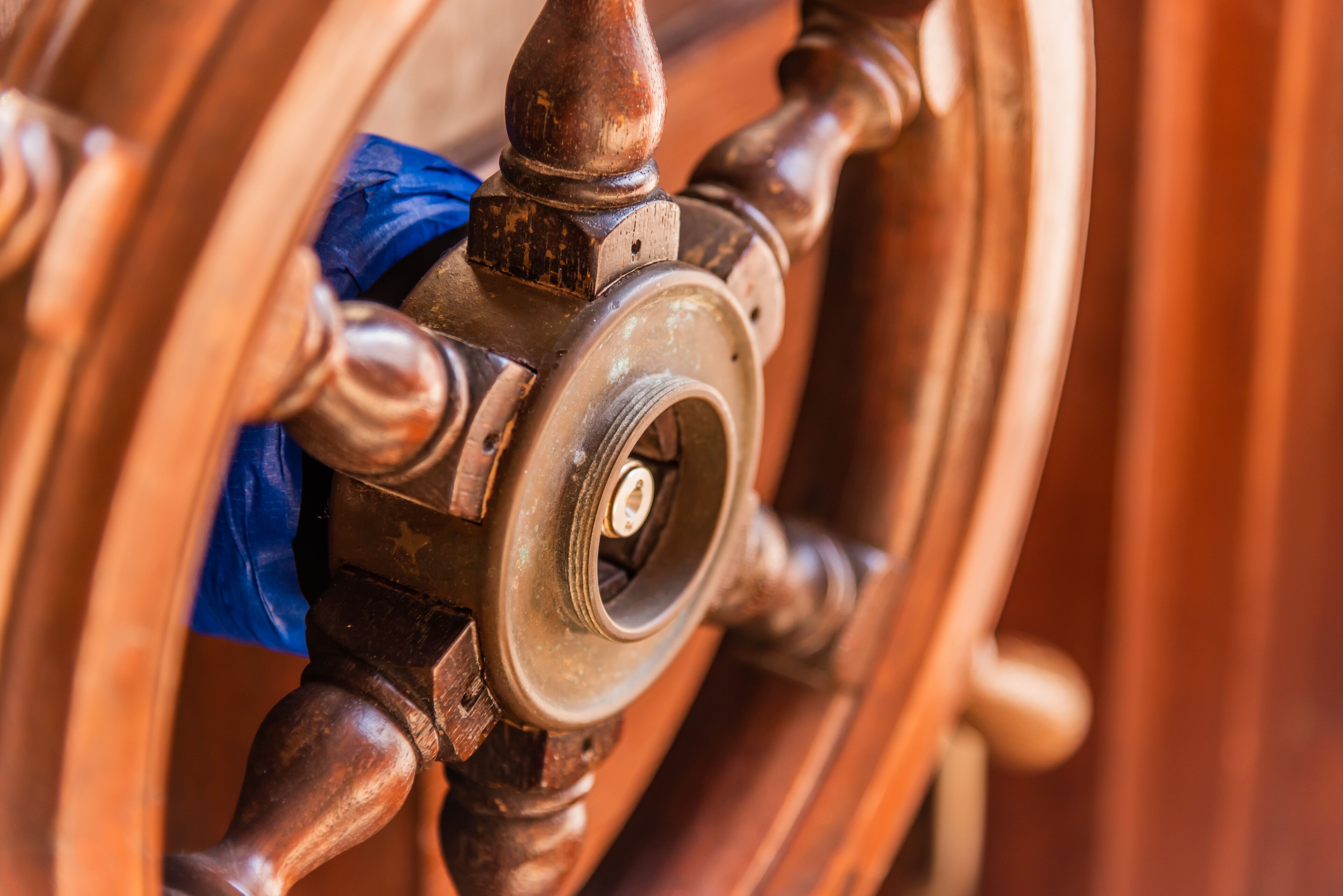 A close-up of a brass valve with a keyhole, surrounded by wooden elements.