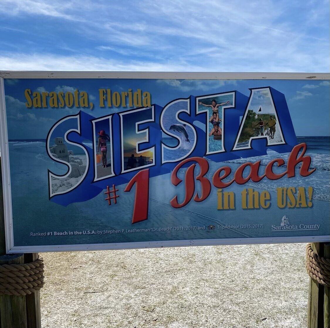 A signboard for Sarasota, Florida, highlighting it as the #1 beach in the USA.