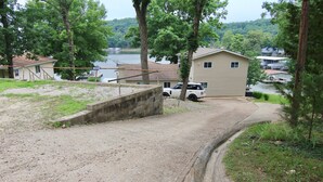 A gravel driveway leading to a house with a dock by a lake. - JOMO - Unit 2 TriTerrace *Relax Lakefront *Enjoy Fam (Rocky Mount)