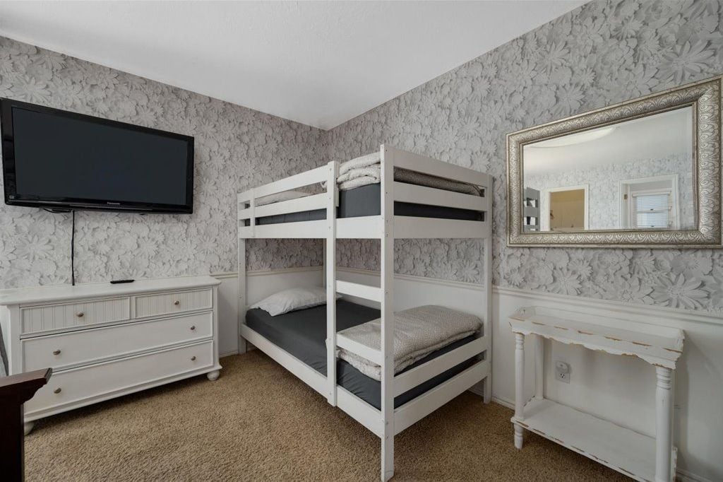 Bedroom with a twin-over-twin bunk bed and TV