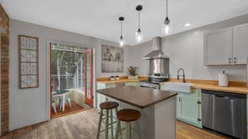 Kitchen with island seating and French doors to the sunroom