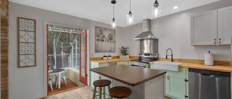 Kitchen with island seating and French doors to the sunroom