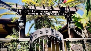A gated entrance with a wrought iron gate, a palm tree, and a sign with the number 1709. - Waterfront Oasis w/ Heated Pool and Spa, and Close to Beach! (Fort Lauderdale)
