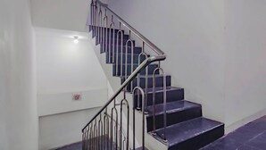 A staircase with metal railings and dark steps. - OYO 89994 Kartini House (Jakarta)