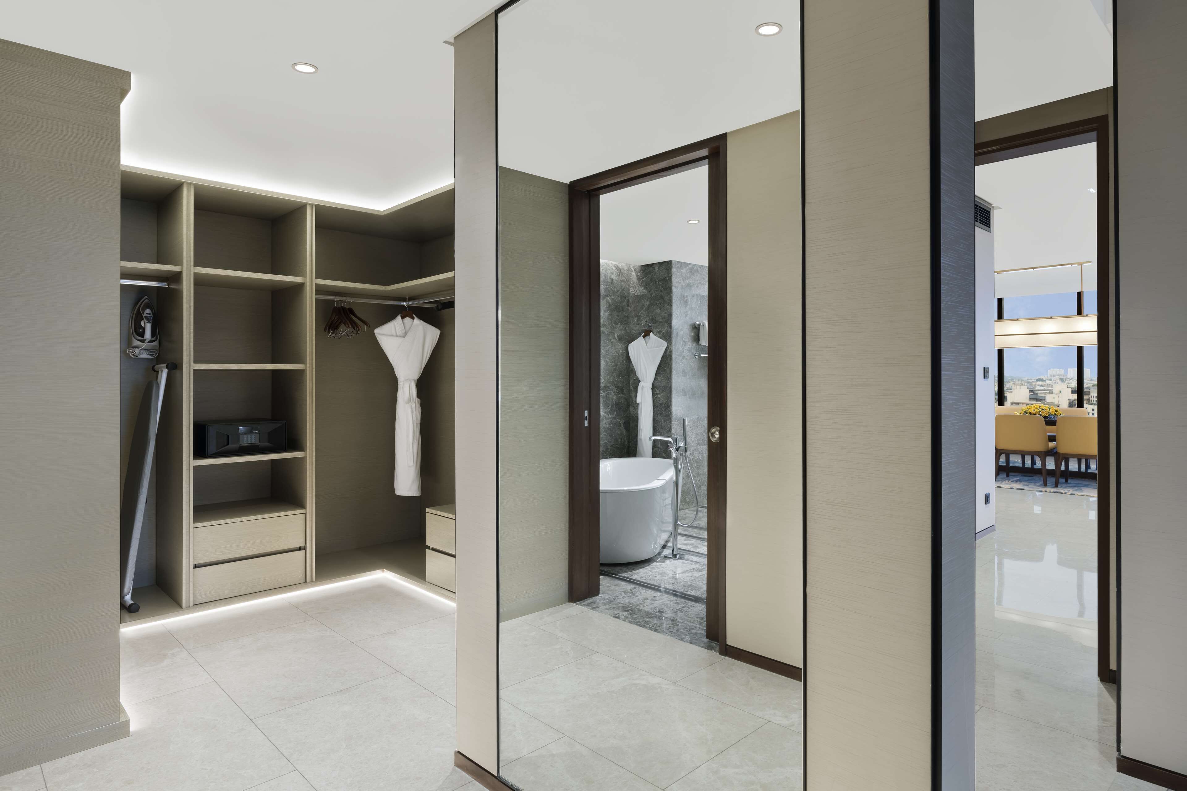 A modern bathroom with a walk-in shower, a built-in toilet, and a vanity with a mirror.