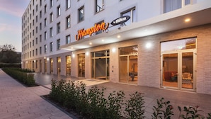 A modern hotel with a prominent 'Hampton by Hilton' sign, large windows, and a brick facade. - Hampton by Hilton Konstanz (Konstanz)