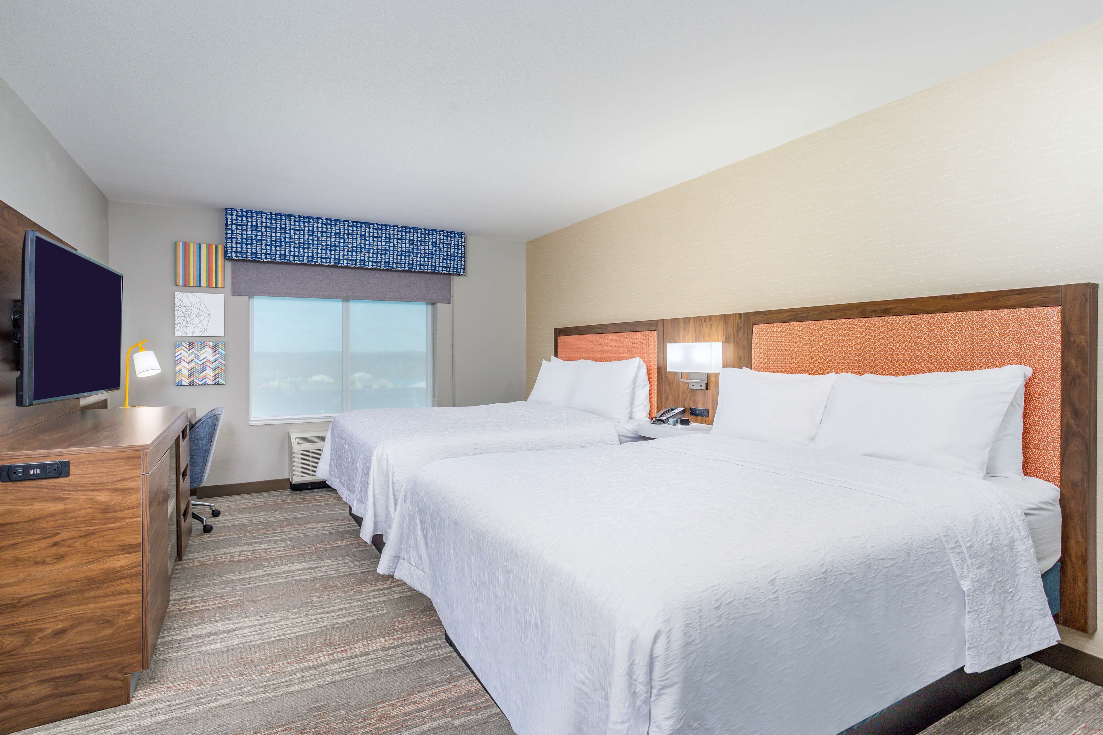 pillow-top beds, desk, laptop workspace, blackout curtains