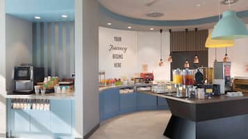 Un café moderne avec un comptoir central, des distributeurs de boissons et un mur décoré de citations inspirantes.