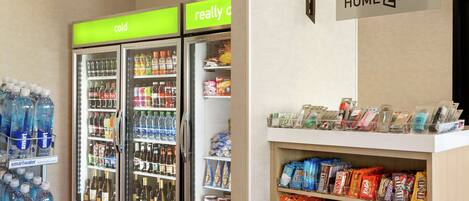 A vending area with snacks and beverages, including a sign for 'HOME2MKT'.