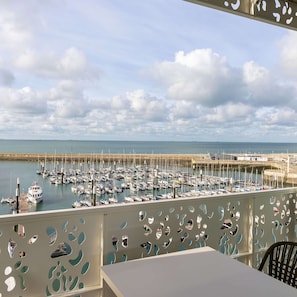 Enjoy breathtaking views of the marina from this balcony.