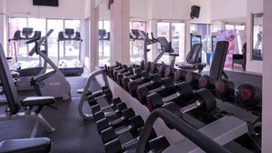 A gym with treadmills, weight machines, and dumbbells. - Sutan Raja Hotel Kolaka (Kolaka)
