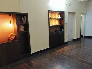 Stylish hallway with shelving units and a door leading to further exploration.