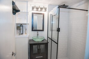 A modern bathroom with a glass sink, a mirror, and a glass-enclosed shower. - Heart of the Bluegrass close to all attractions in Central Kentucky (Lexington)