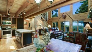 A spacious wooden cabin interior with a kitchen, dining area, and living room. - Hot Tub & Scenic Mountain Views, Game Room (Mineral Bluff)