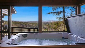 A hot tub with a view of mountains and trees. - Stunning Mountain Sunset Views, screened-in HotTub (Mineral Bluff)