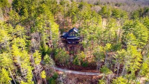 A cabin surrounded by dense forest, accessible by a narrow path. - Stunning Mountain Sunset Views, screened-in HotTub (Mineral Bluff)