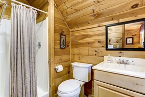Bathtub, hair dryer, towels, shampoo