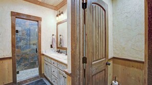 Bathtub, hair dryer, towels, shampoo