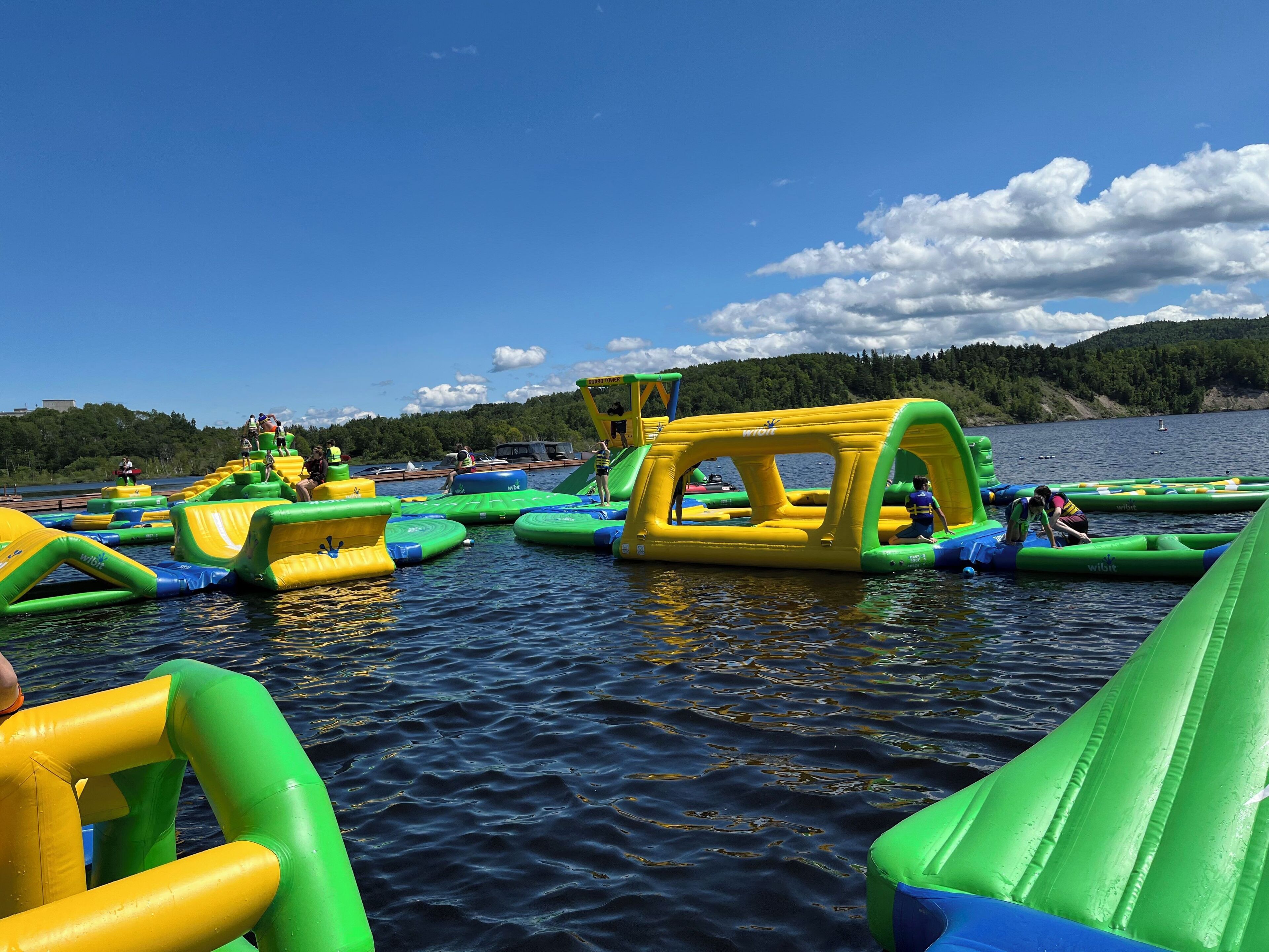 An inflatable water park with various play structures on the water.