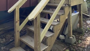 A wooden staircase leading to a door on a building with a window. - Lovelyt one bedroom nestled in the white mountains and the lakes region of NH (ORFORD)