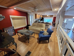 Cozy living area with a fireplace, sofa, and armchair, perfect for relaxing.