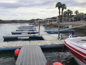 Stroll along the marina's pedestrian walkway, taking in the sights of docked boats and palm trees.