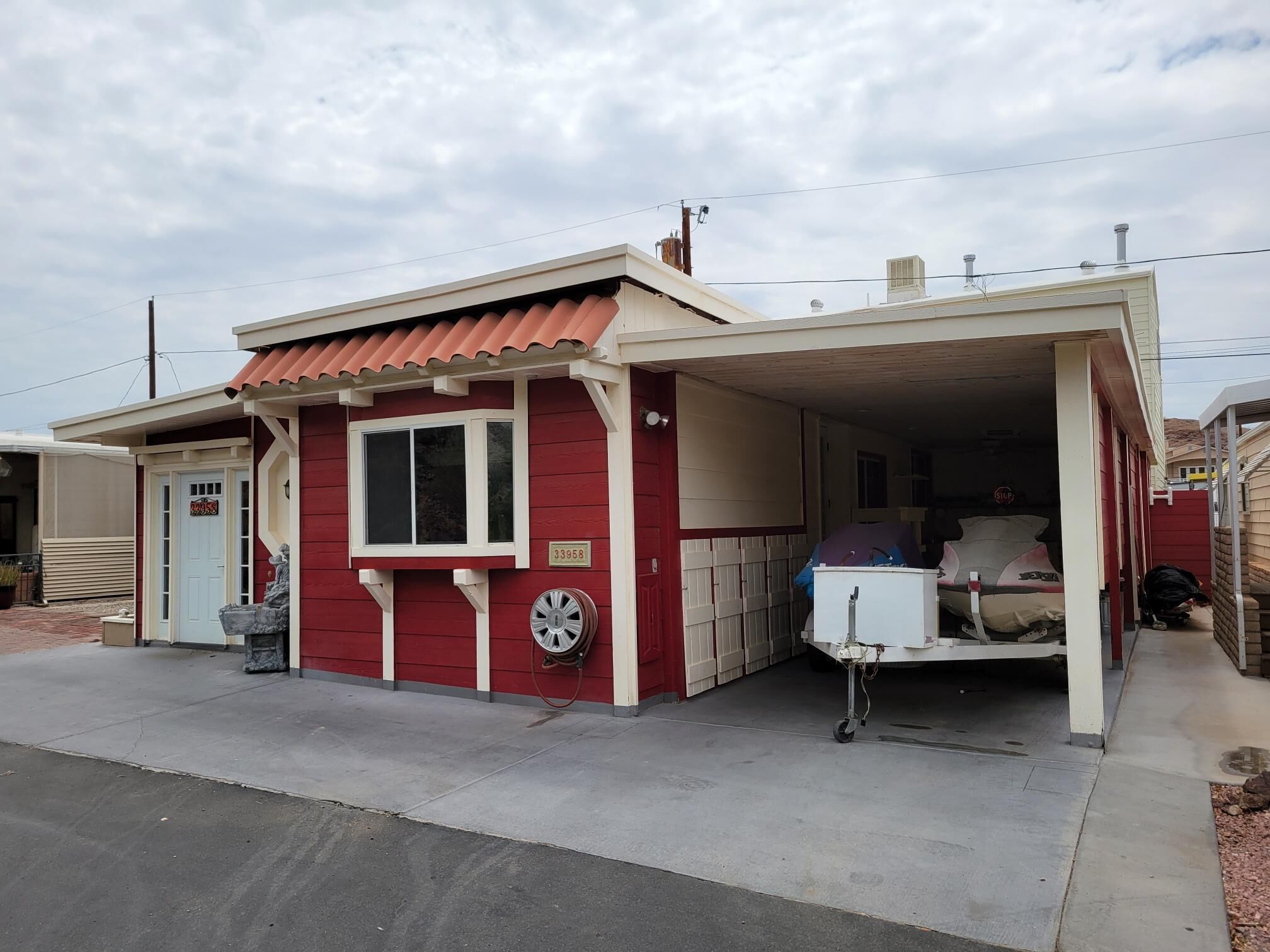 A small, single-story building with a red exterior and a white garage door.