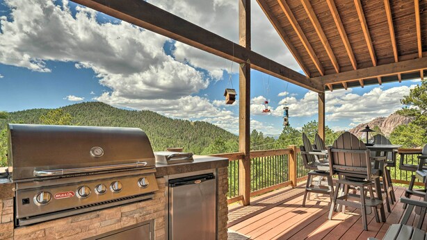 An outdoor deck with a grill, seating, and a scenic mountain view. - Cripple Creek Mountain Getaway w/ Hot Tub & Views! (Cripple Creek)