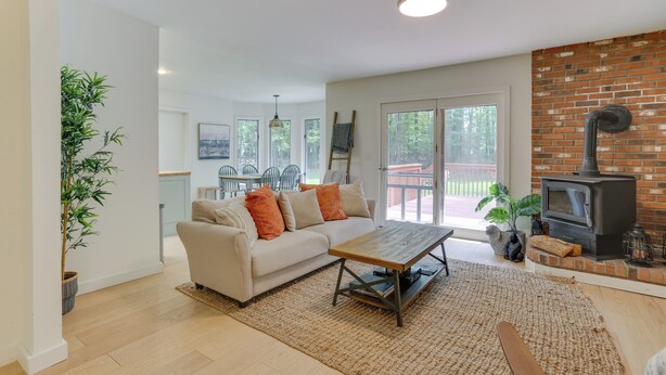 A modern living room with a sofa, coffee table, and a fireplace.