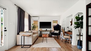 Una sala de estar moderna con un sofá, una mesa de centro y un televisor.