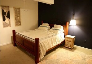 Cozy bedroom with a comfortable bed, nightstand, and lamp.