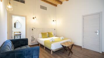 A bedroom with a bed, bedside table, and a chair.