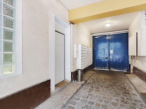 Enter a welcoming space with a hallway leading to a service entrance or lobby area.