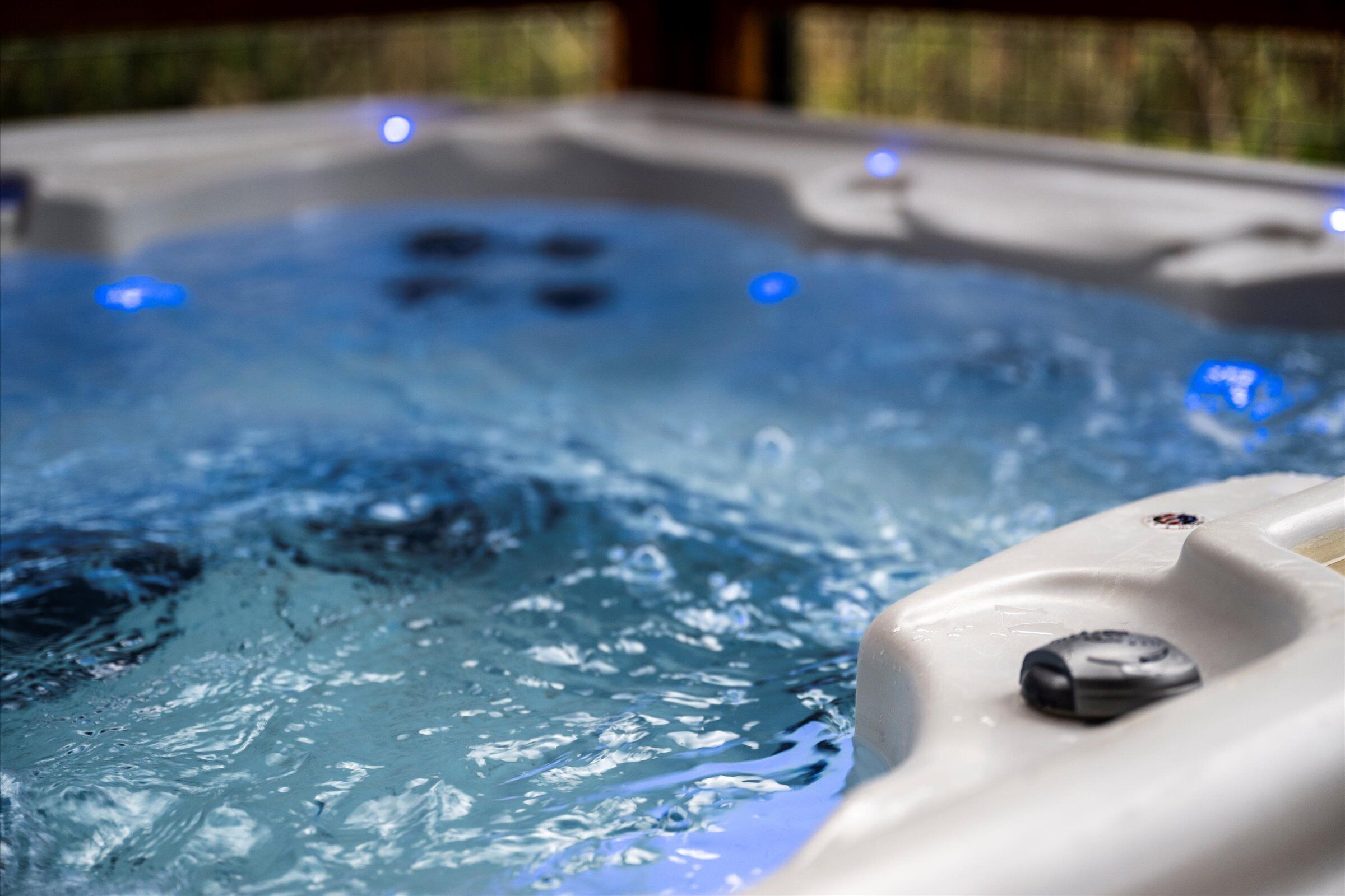 A hot tub with water jets and LED lights.