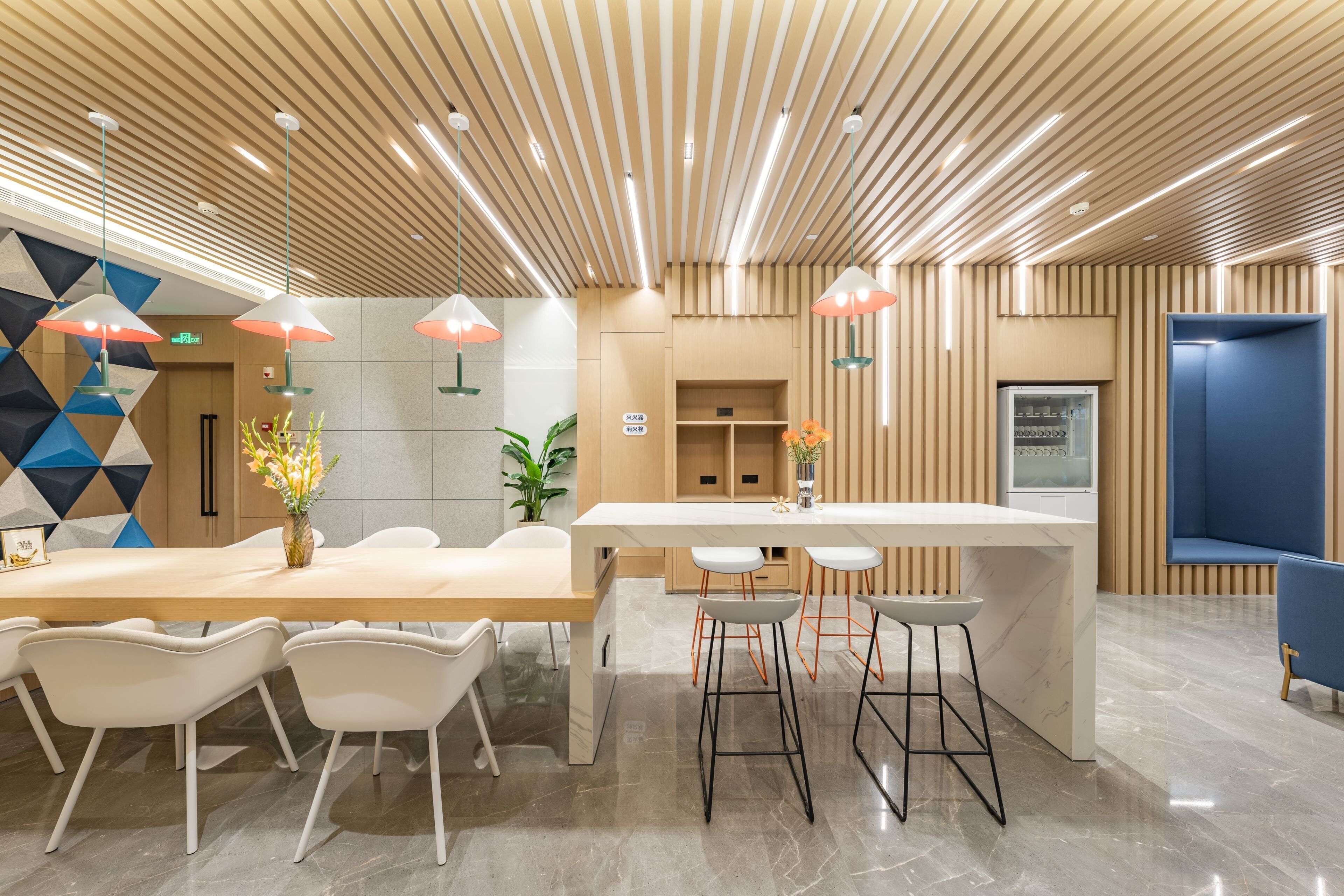 A modern interior with a wooden ceiling, a central island with bar stools, and a seating area with white chairs.