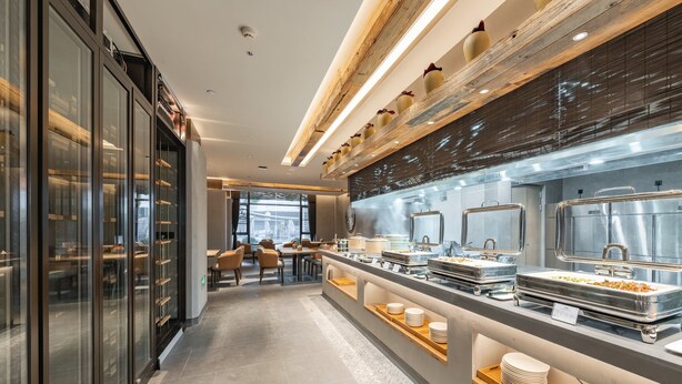 A modern hotel kitchen with buffet-style service, glass-fronted storage, and a clean, contemporary design. - Holiday Inn Express Shanghai Expo Centre by IHG (Shanghai)