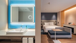 A modern hotel room with a large bathroom mirror, a bedside table, a sofa, and a small desk. - Holiday Inn Express Shanghai Expo Centre by IHG (Shanghai)