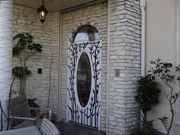 Stunning arched doorway with a decorative glass panel, framed by a unique tree branch design.