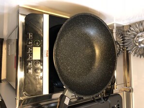 Une cuisine équipée d’une cuisinière et d’une poêle.