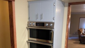 A corner kitchen with a built-in oven and a microwave. - Single Story Chic' One mile from Downtown,  with Tesla 220v Outlet in Garage (Prescott)