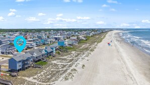 A coastal residential area with beachfront properties, a sandy beach, and a clear sky. - "All Good" Oceanfront 2 bedrooms, 2 bathrooms. (Holden Beach)