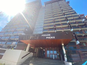 A high-rise building with a prominent entrance labeled 'PEGASE PHENIX.' - travelski home classic - Résidence Phénix - Studio 5 personnes Vue Vallée 0904 (Villarembert)