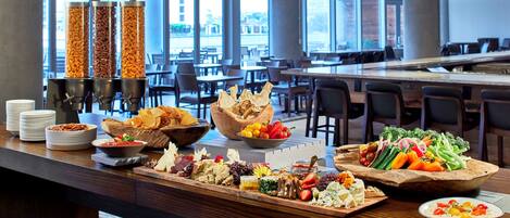 A buffet with various food items and a coffee station.