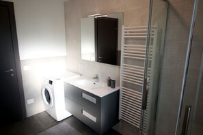 Premium appartement | Badkamer | Een douche, een regendouche, een bidet, handdoeken