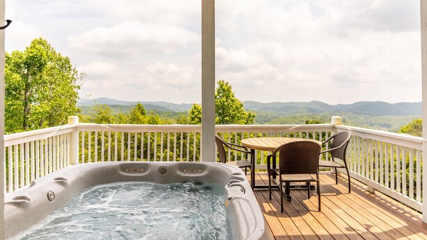 A hot tub on a wooden deck with a view of mountains. - Blue Ridge Blessing - Pet Friendly! Views, hot tub, great location on App Ski Mtn! (Blowing Rock)